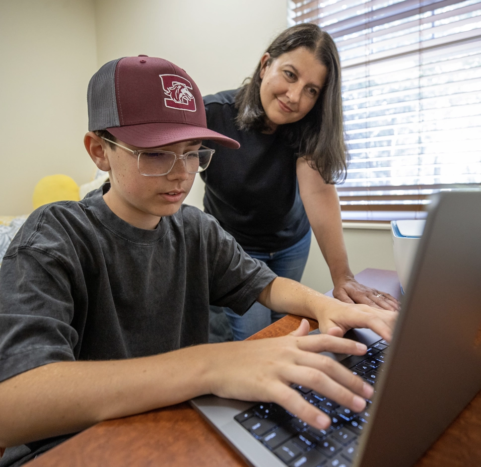 Adult learner who is a mother helping her son with homework